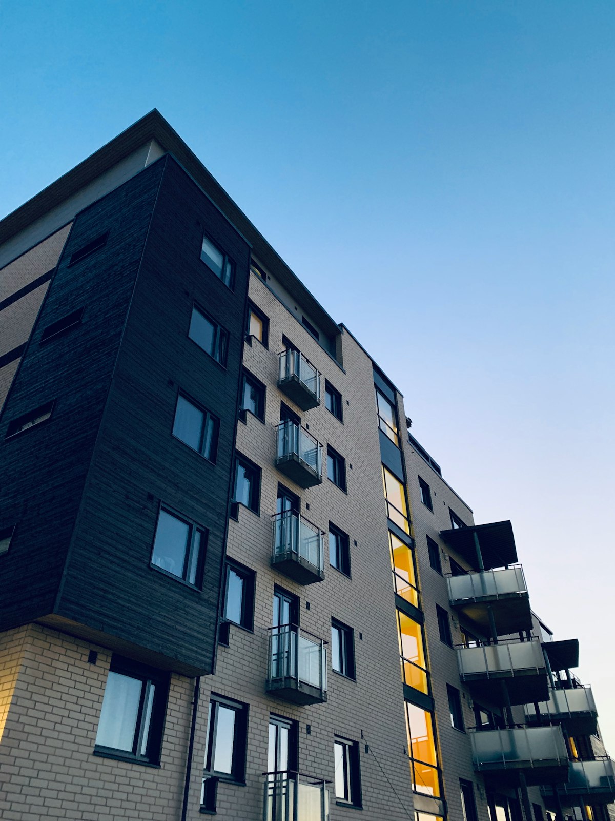 Low-angle view of a high-rise apartment building.
